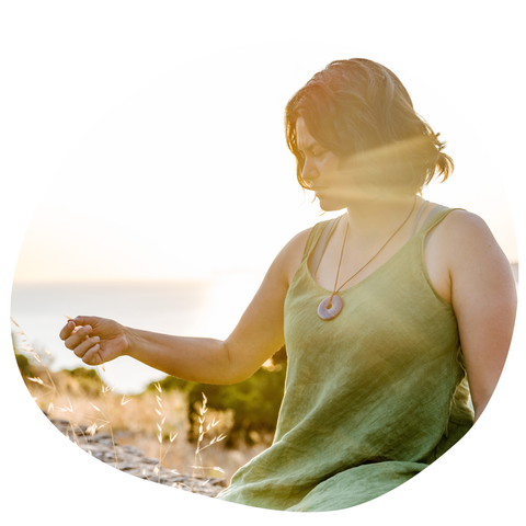 Woman in a green dress with a blurred background of nature